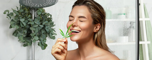 Woman in the shower, smelling a CBD leaf