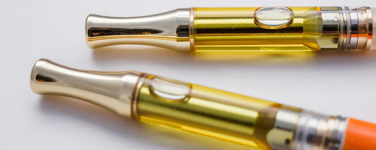 CBD vape cartridges on a white table