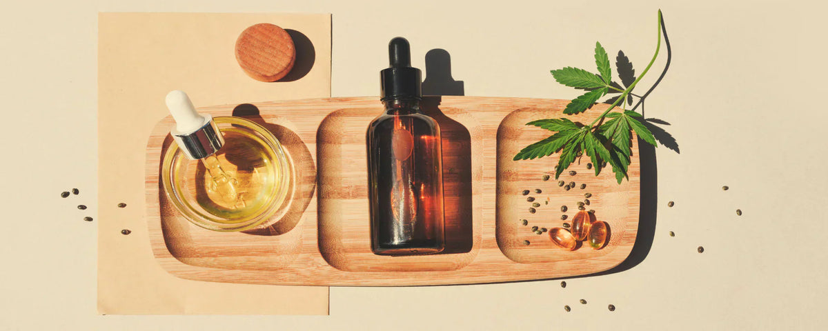 CBD Beauty Oil on wooden plank with hemp leaves and hemp seeds