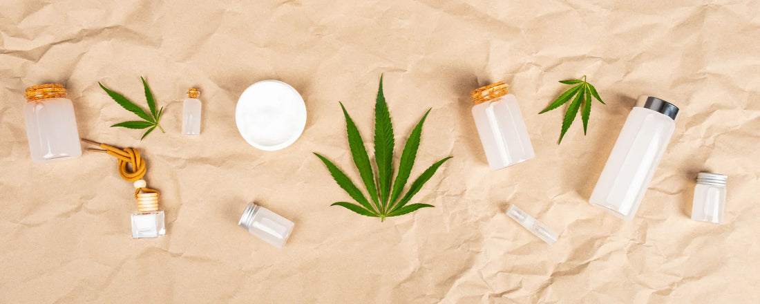 CBD skincare product range including CBD oils, balms and more with hemp leaves surrounding