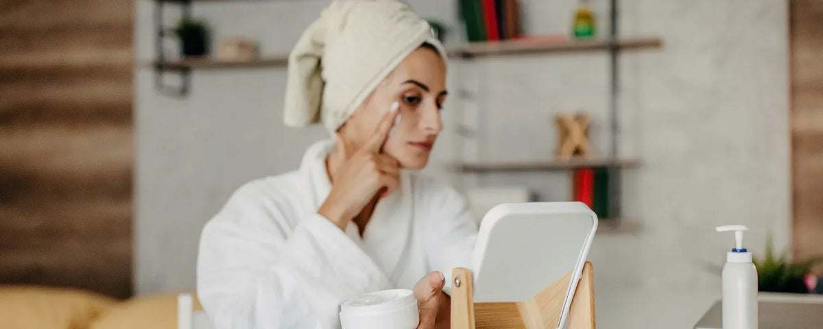 Woman applying CBD cream to her face as part of her morning routine