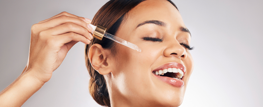 Lady adding CBD drops to her face