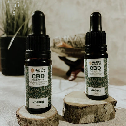 Happy Hemper 250mg Cold Pressed CBD Oil on chopped wood blocks | The CBD Hut