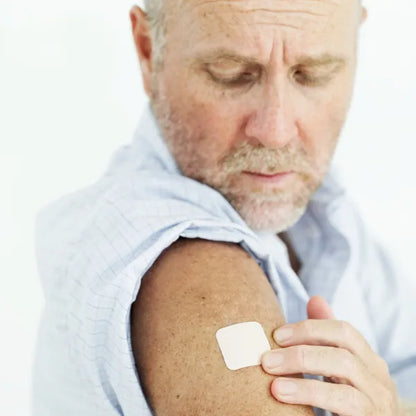 Man applying CBD patch to his forearm