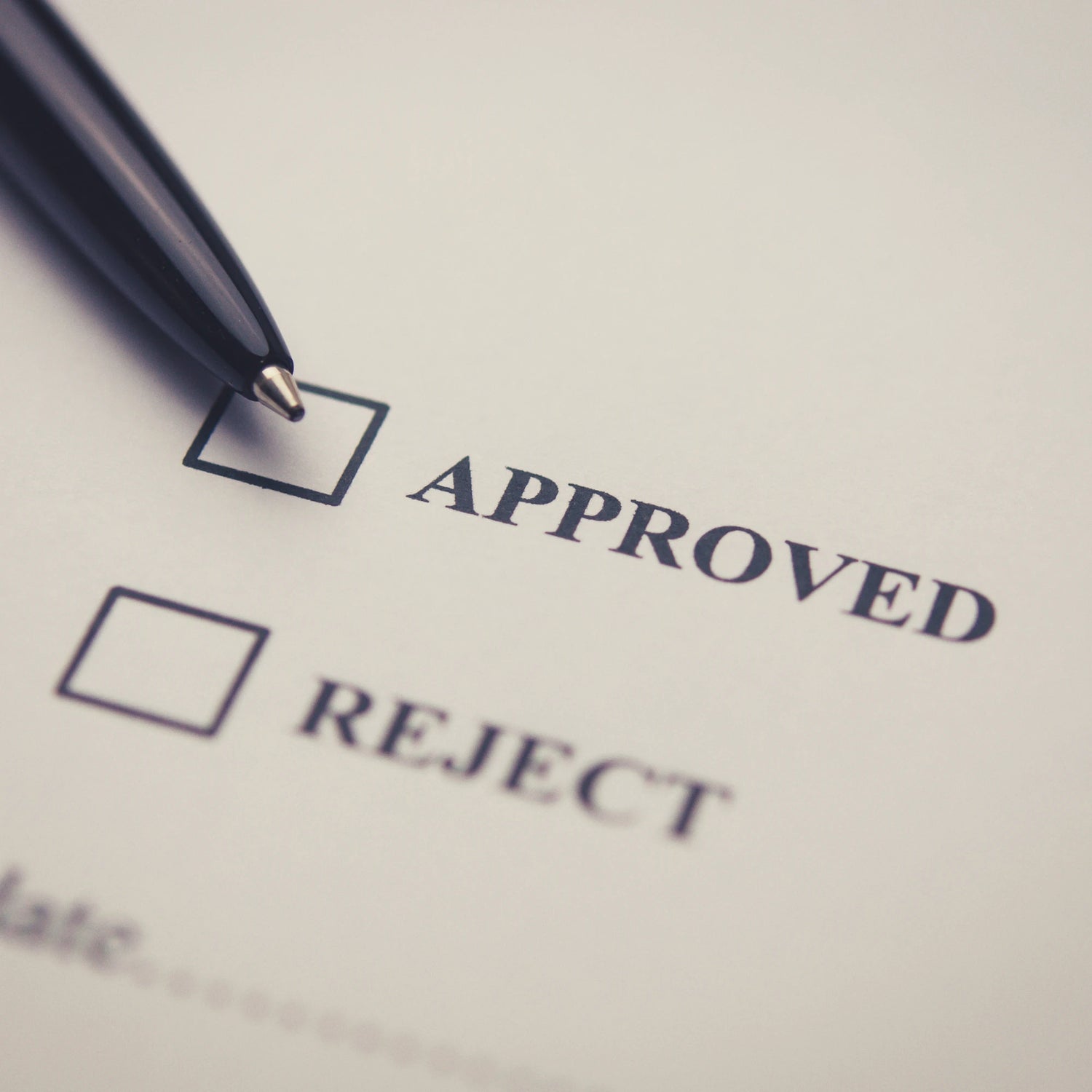Checklist with 'Approved' and 'Reject' options, pen poised over 'Approved'.