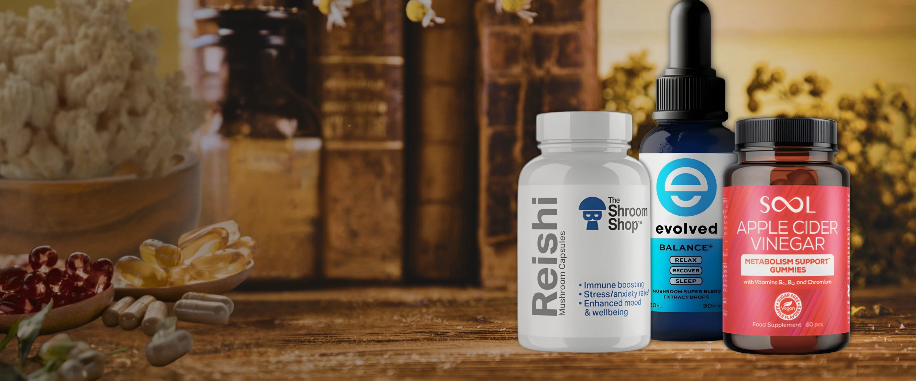 Nootropic mushroom products including oil, gummies & capsules on a wooden table top.